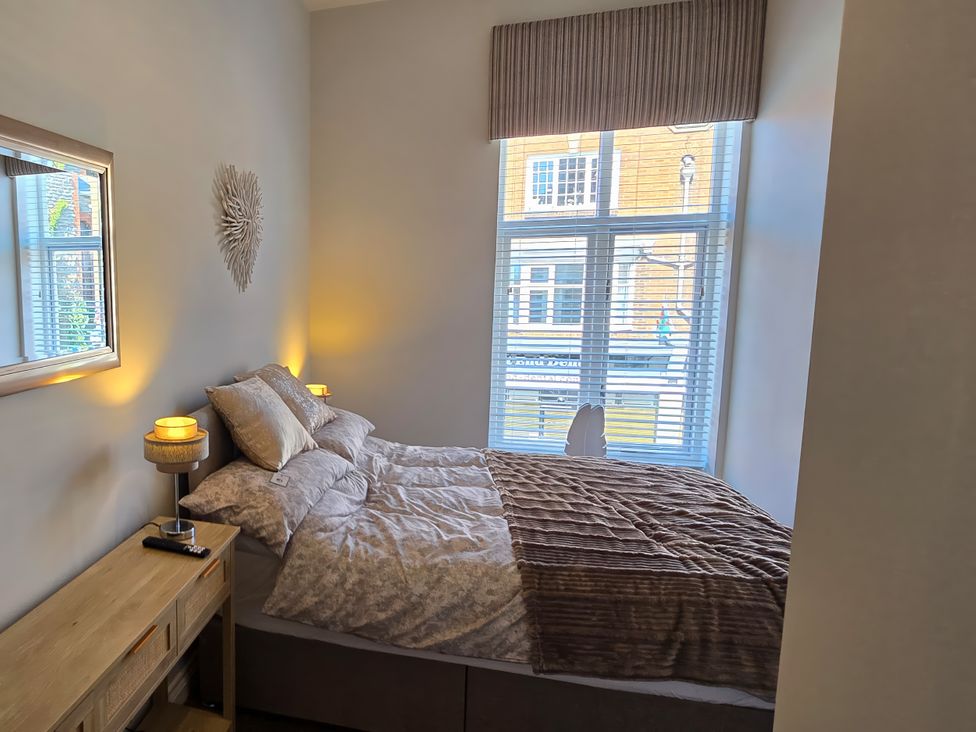 A bedroom with a bed and a window at 2 Fern Avenue in Prestatyn