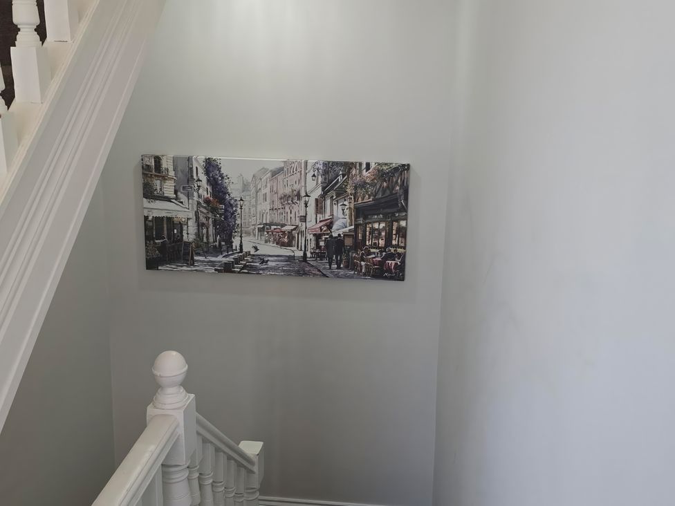 A staircase with a painting on the wall at 2 Fern Avenue Prestatyn