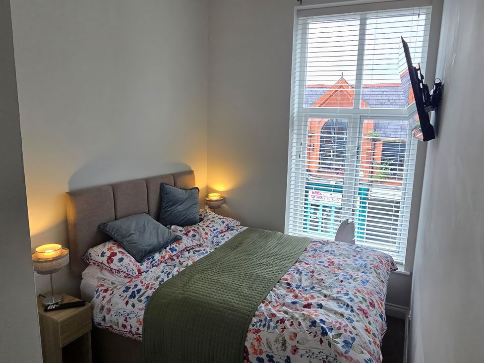A bedroom with a bed and television at 2 Fern Avenue in Prestatyn