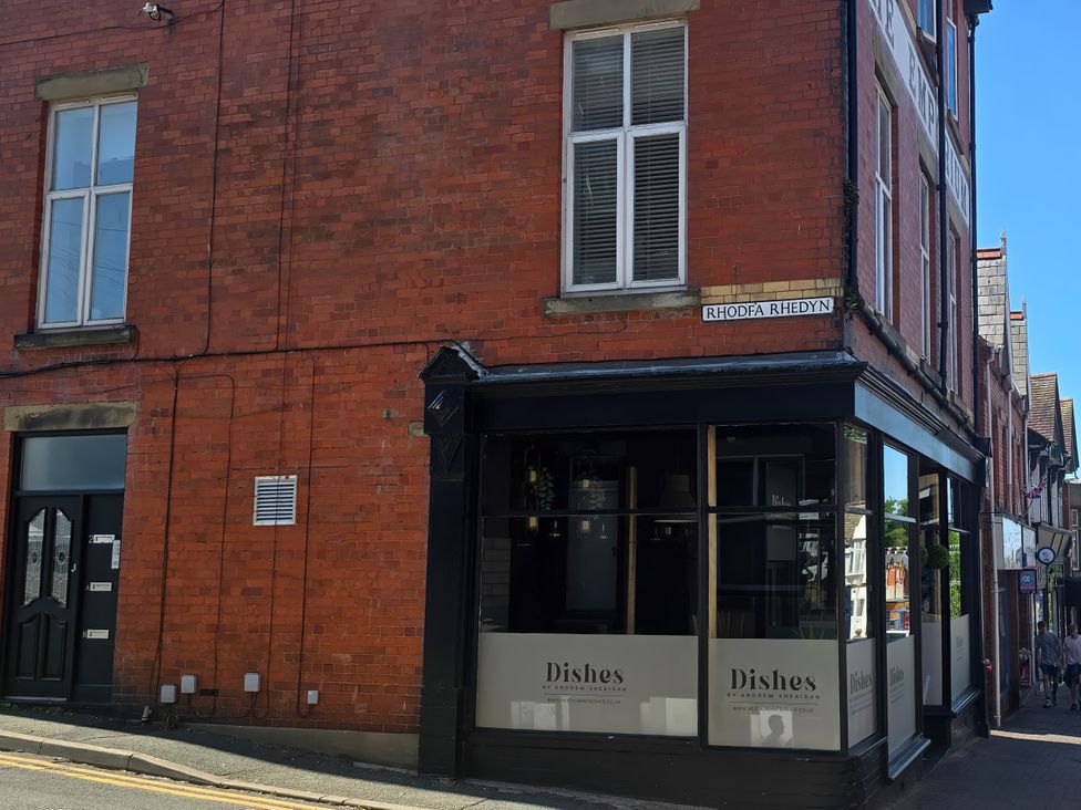 A shop front with a sign at Dishes in Prestatyn
