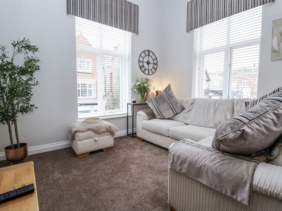 A living room with a sofa and plant at No 2 Emporium Apartments in Prestatyn