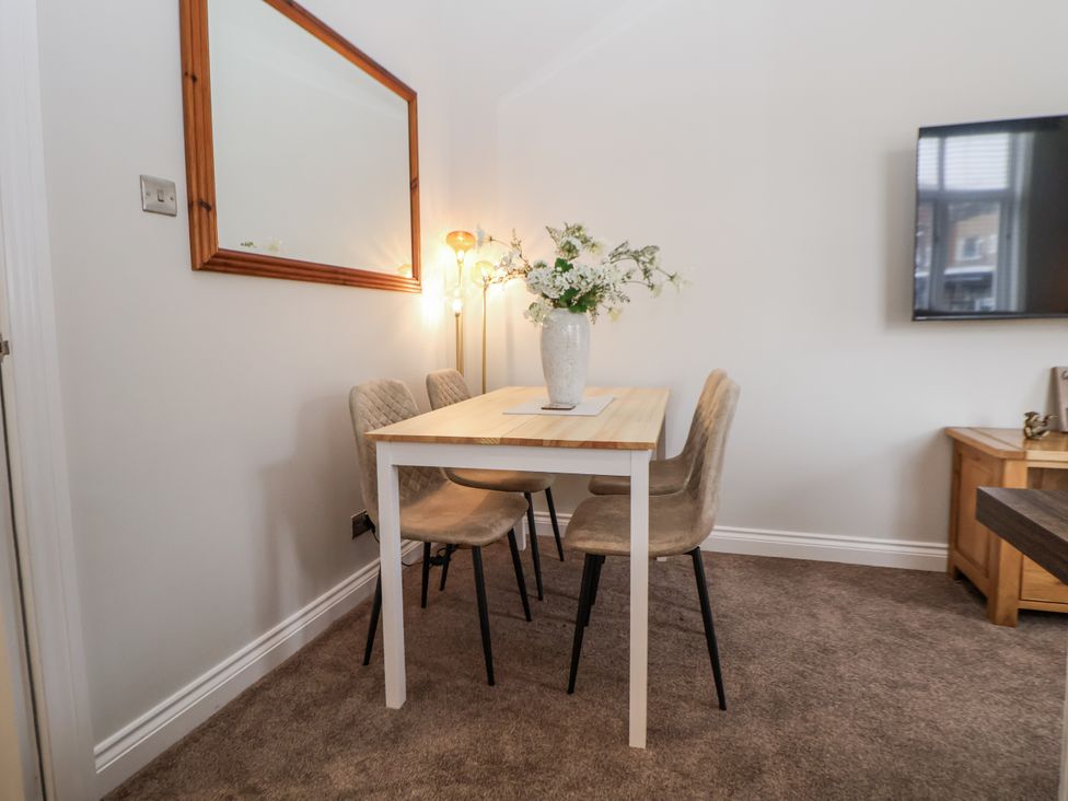 A dining room with a table and chairs at No 2 Emporium Apartments in Prestatyn