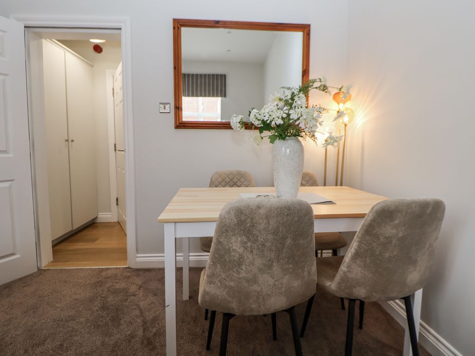 A dining room with a table and chairs at No 2 Emporium Apartments Prestatyn
