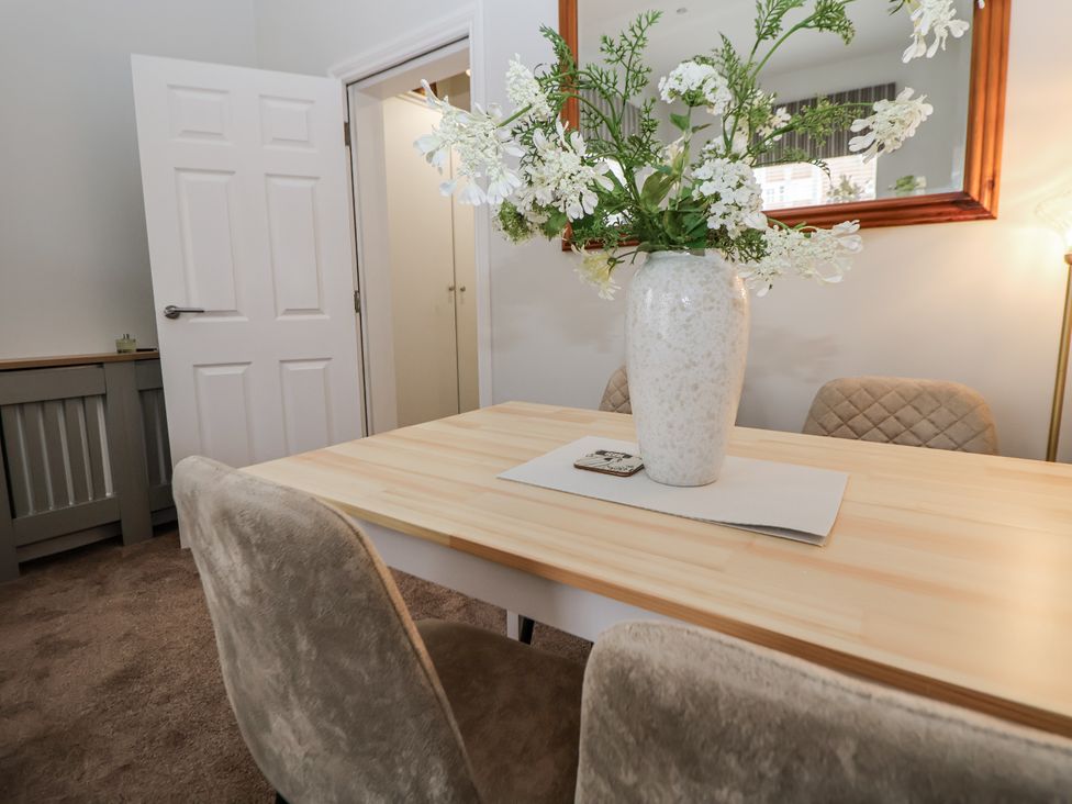 A dining room with a table and chairs at No 2 Emporium Apartments Prestatyn