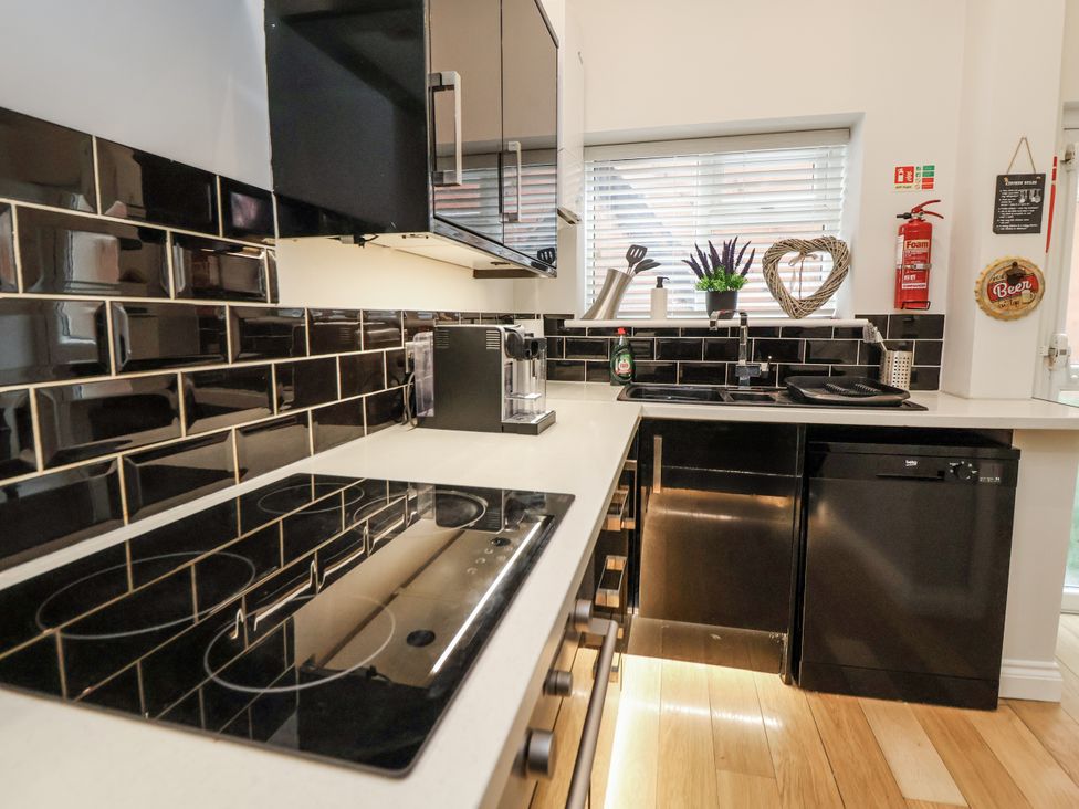 A kitchen with a countertop sink and appliances at No 2 Emporium Apartments Prestatyn