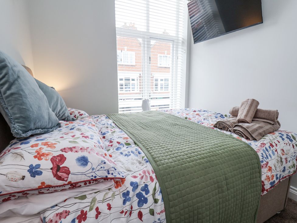 A bedroom with a bed and tv at No 2 Emporium Apartments in Prestatyn