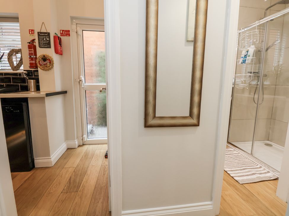 A bathroom with a mirror and shower at No 2 Emporium Apartments Prestatyn