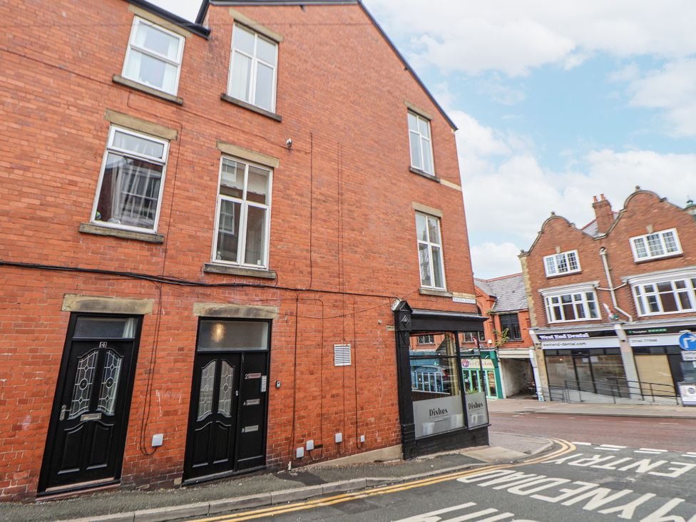 A brick building with multiple windows and entrance doors at No 2 Emporium Apartments Prestatyn