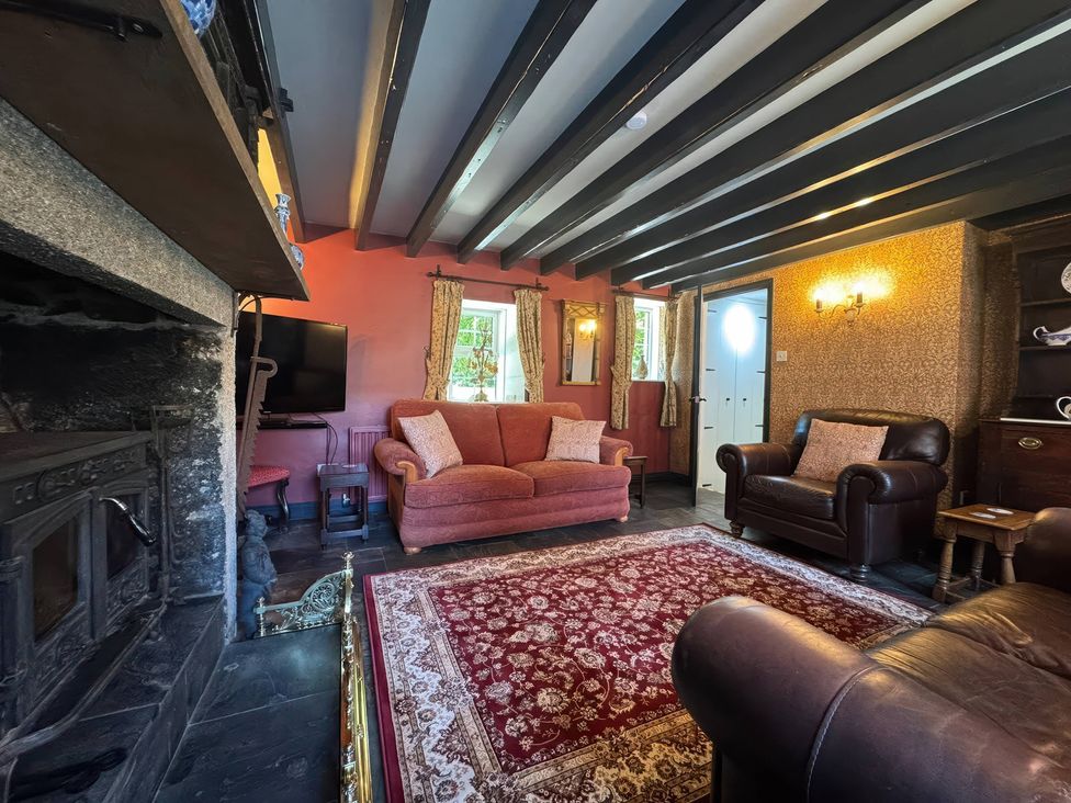 A living room with a sofa and armchair at St. James Cottage Liskeard