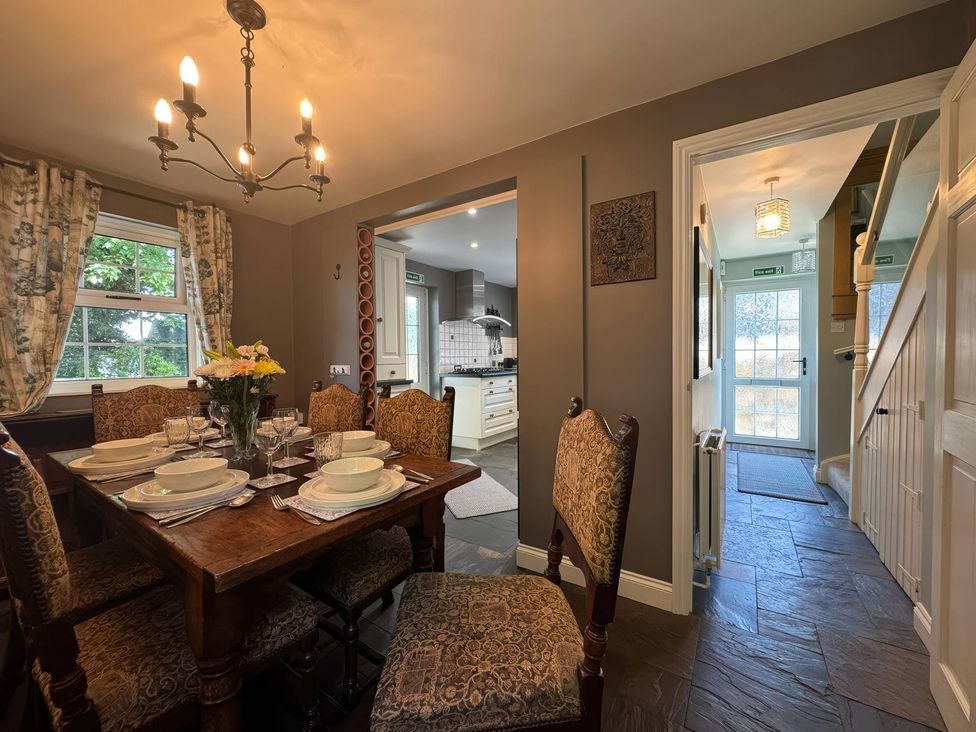 A dining room with a table and chairs at St. James Cottage in Liskeard