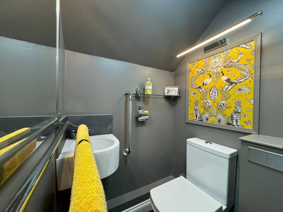 A bathroom with a sink and a white toilet at St. James Cottage in Liskeard