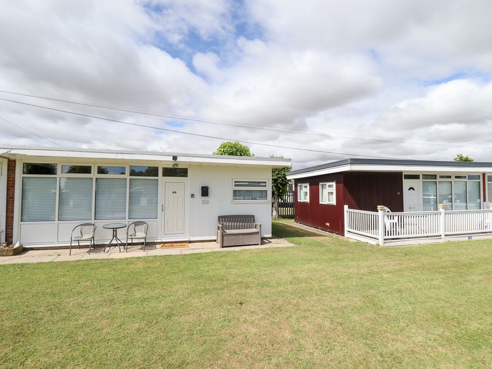 A house with a front entrance and outdoor seating at 66 Cherry Park Skegness