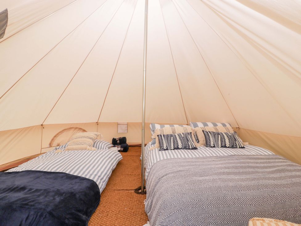 A tent with two beds and pillows at Bell 2 in Shades Farm near Malmesbury