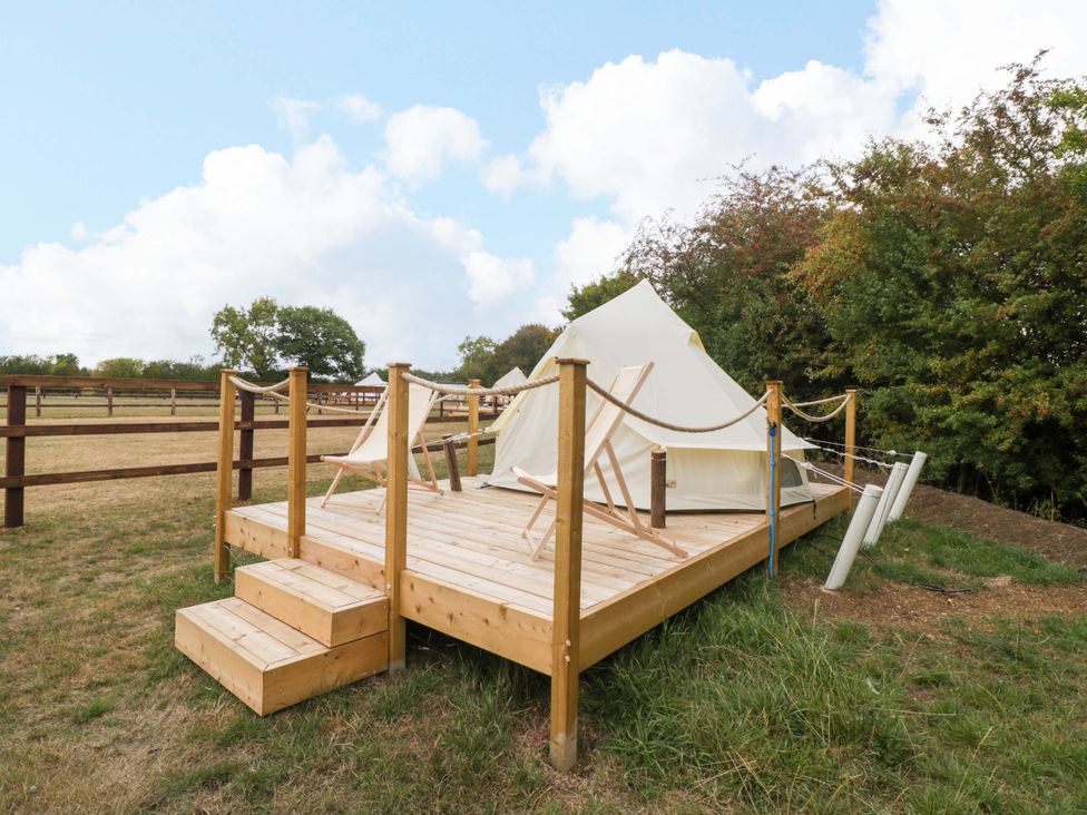 A wooden deck with a tent at Bell 3 near Shades Farm Malmesbury