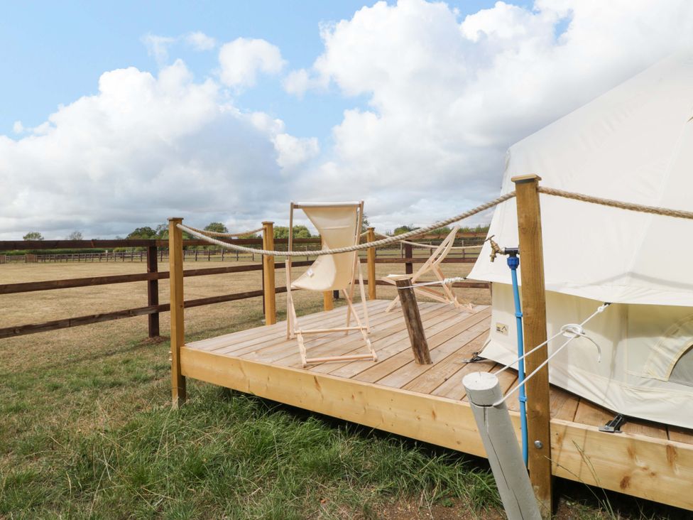 A deck with two chairs and a tent at Bell 3 Shades Farm near Malmesbury