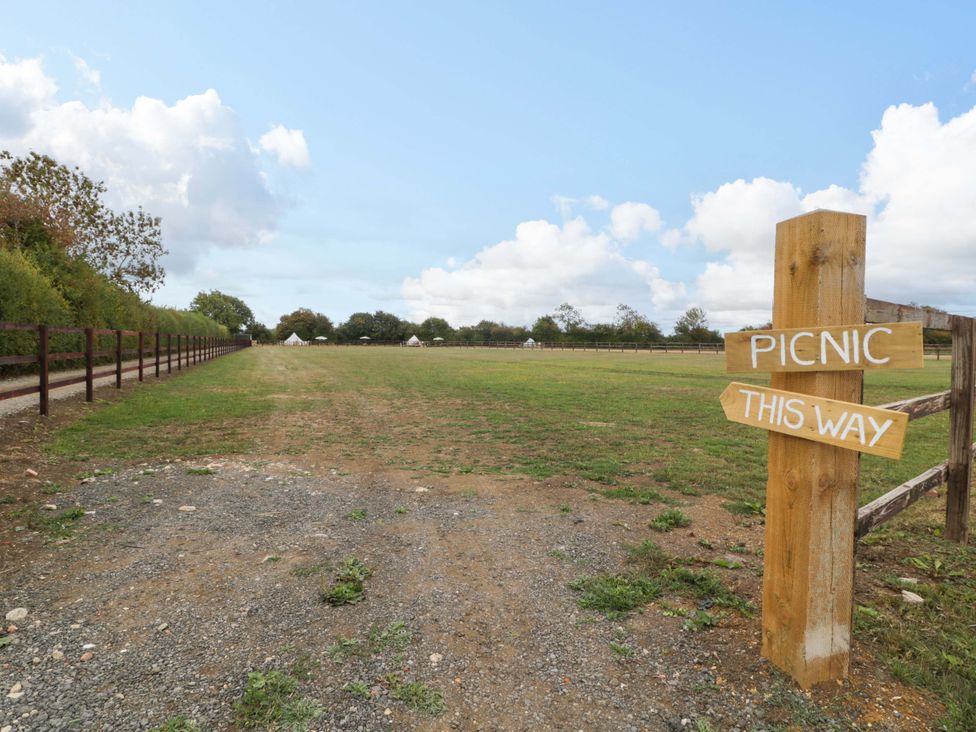 A pathway leading to a picnic area at Bell 3 Shades Farm near Malmesbury
