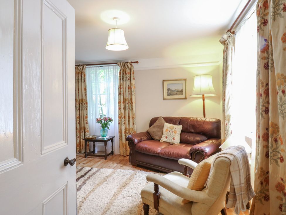 A living room with a sofa, chair, and coffee table at Curry Farm 