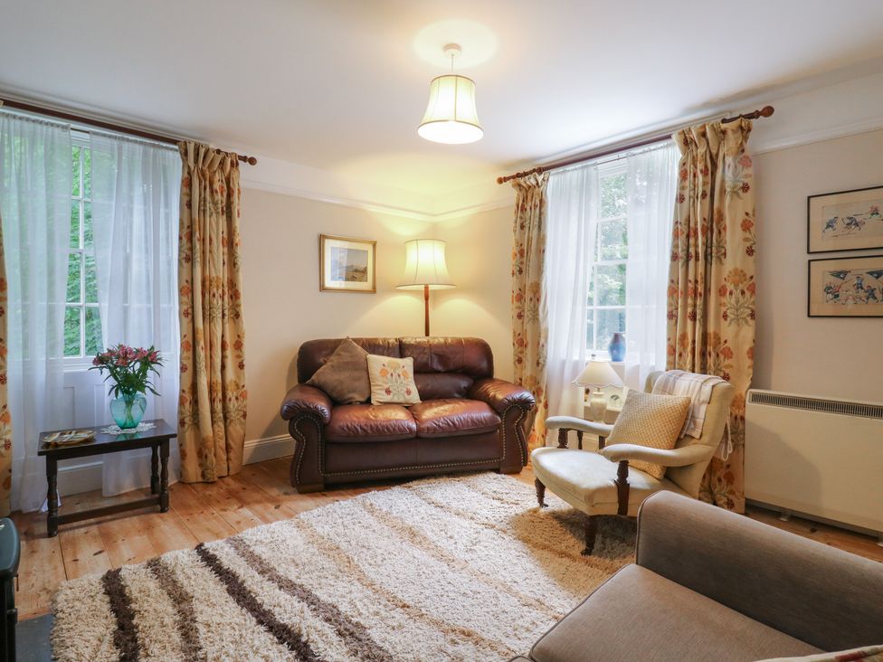 A living room with a sofa and armchair at Curry Farm