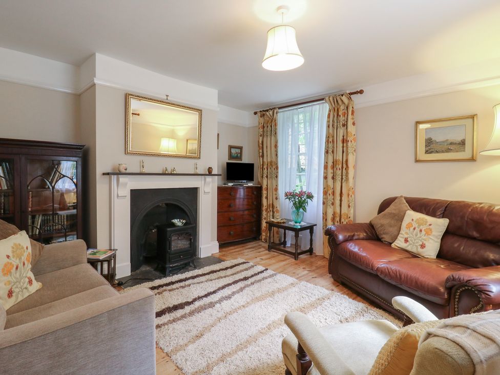 A living room with a fireplace and sofas at Curry Farm 