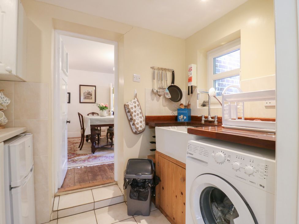 A kitchen with a washing machine and sink at Curry Farm