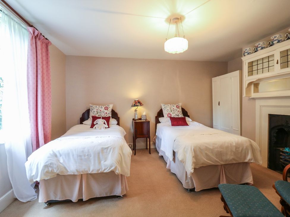 A bedroom with two beds and a nightstand at Curry Farm