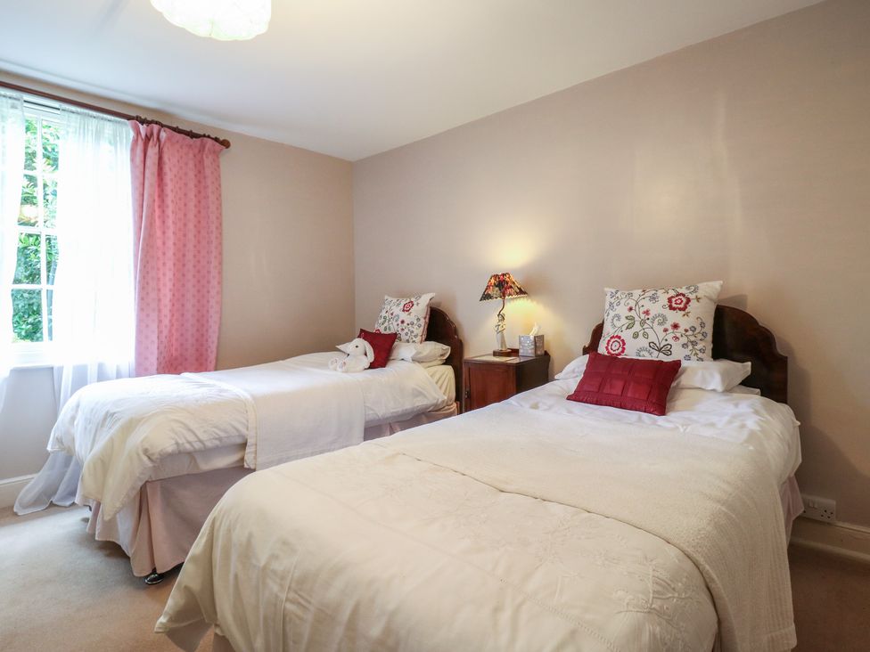 A bedroom with two beds and a window at Curry Farm