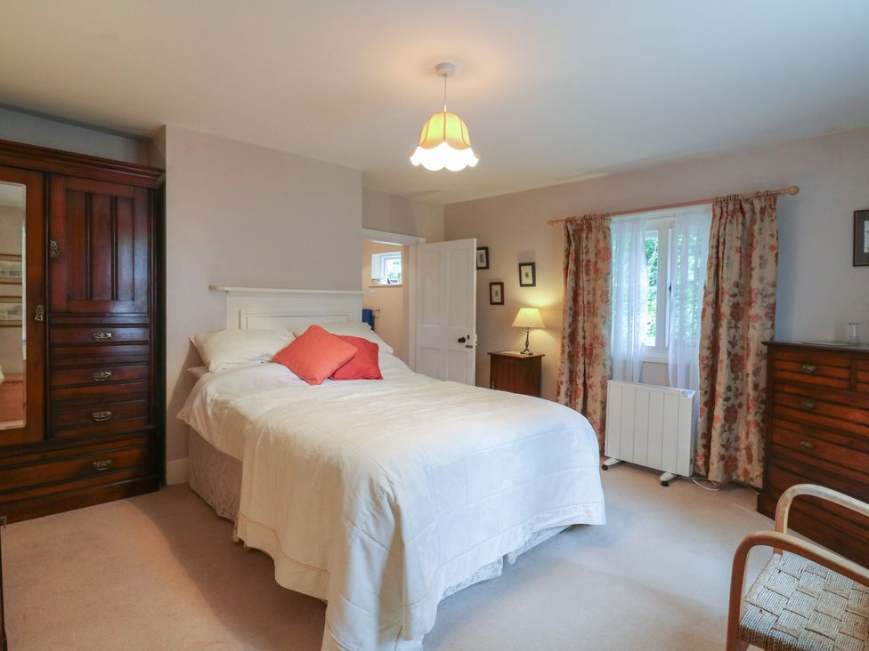 A bedroom with a bed and wardrobe at Curry Farm