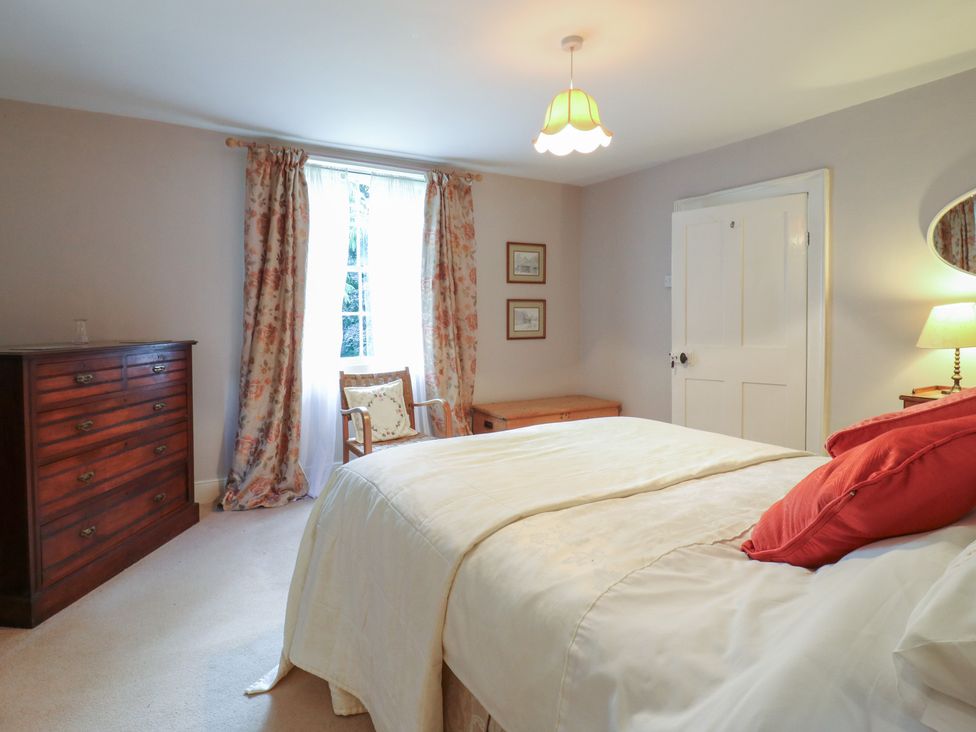 A bedroom with a bed and dresser at Curry Farm