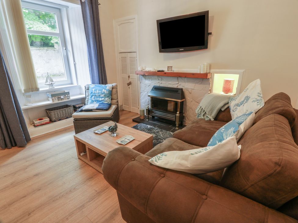 A living room with a sofa and coffee table at 6 George Street Isle of Cumbrae