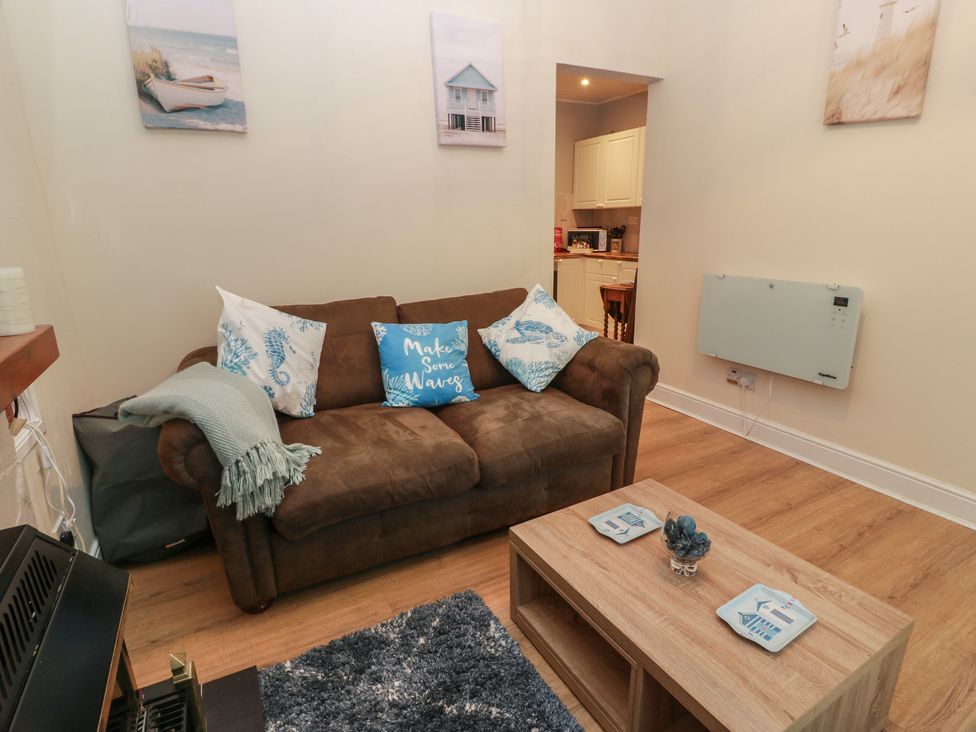 A living room with a sofa and coffee table at 6 George Street Isle of Cumbrae