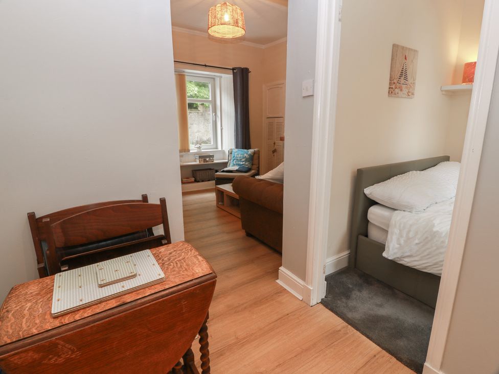 A living room with a sofa and table at 6 George Street in Isle of Cumbrae