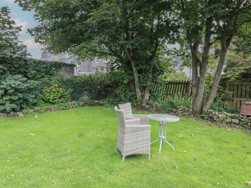 A garden with a chair and table at 6 George Street Isle of Cumbrae