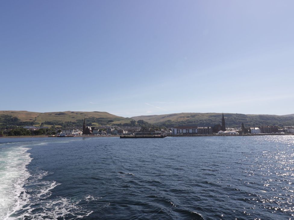 A view of buildings and hills over water at 6 George Street in Isle of Cumbrae