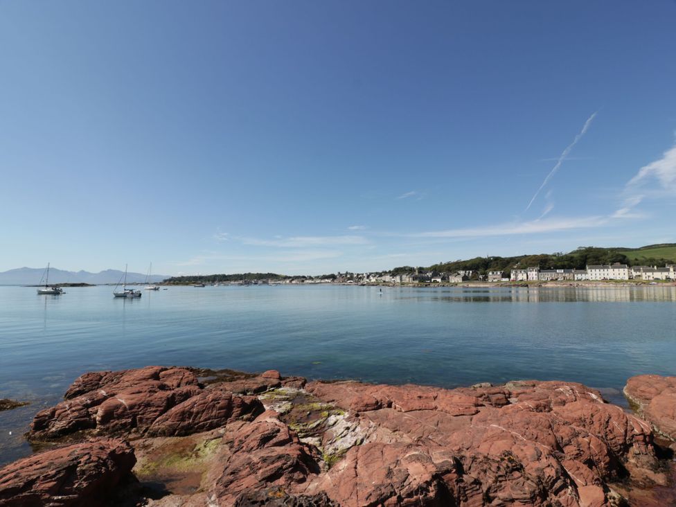 A coastal view with boats on water and a town in the background at 6 George Street Isle of Cumbrae