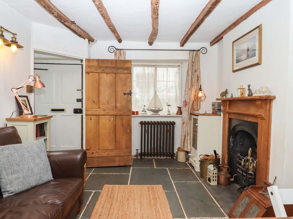 A living room with a sofa and fireplace at Carpenters Cottage Okehampton