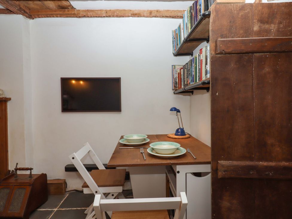 A dining room with a table and chairs at Carpenters Cottage Okehampton