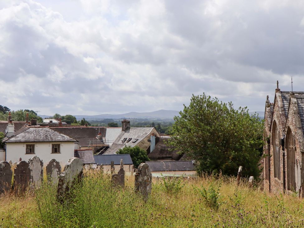 A view of rooftops and gravestones at Carpenters Cottage in Okehampton