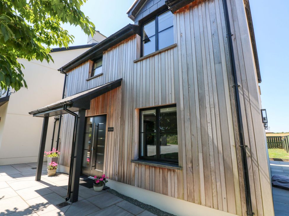 An exterior view of a modern house with wooden cladding at Just A Cottage St Florence