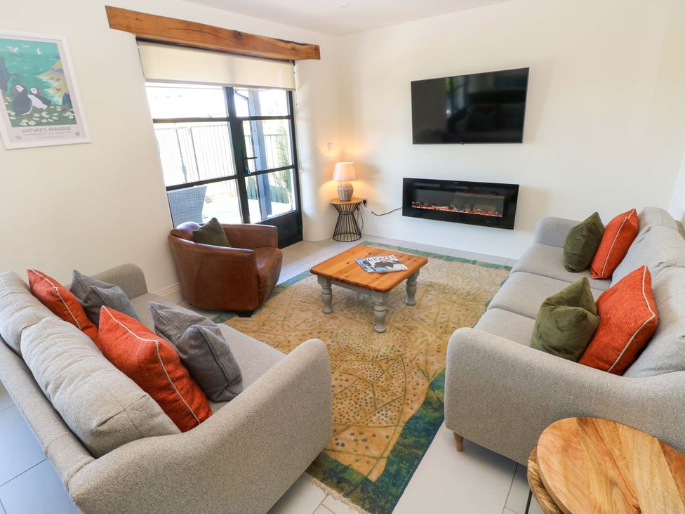A living room with a sofa and armchair at Just A Cottage St Florence