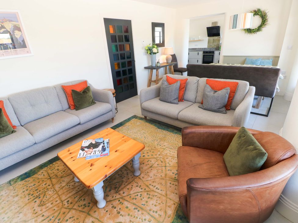 A living room with sofas and a coffee table at Just A Cottage St Florence