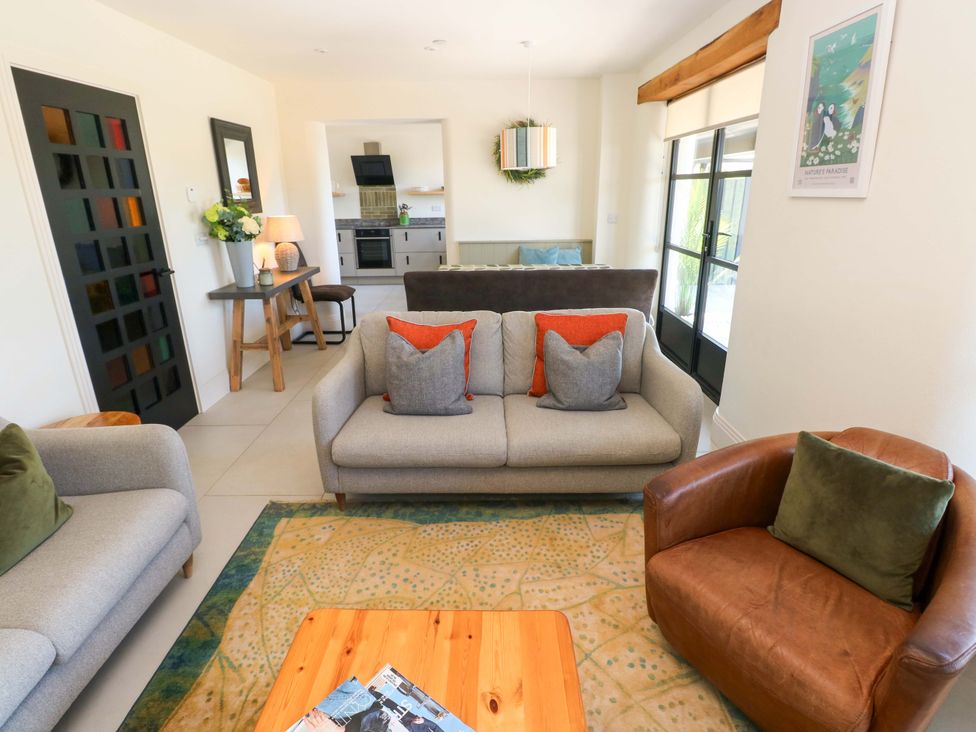 A living room with sofa and armchair at Just A Cottage St Florence