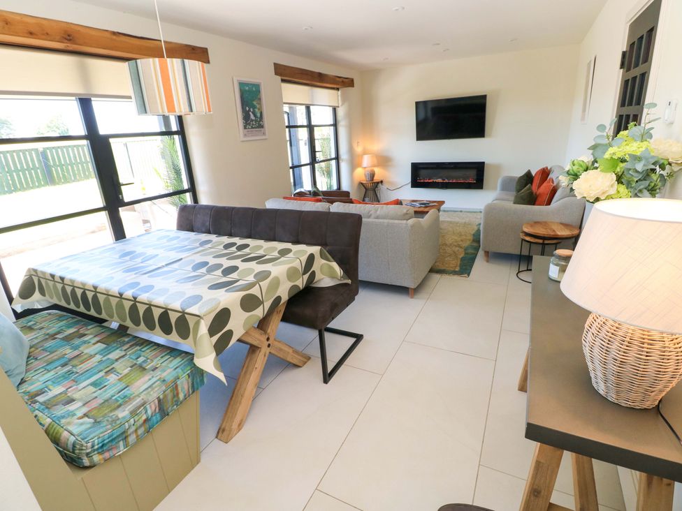 A living room with a dining table and sofa at Just A Cottage in St Florence