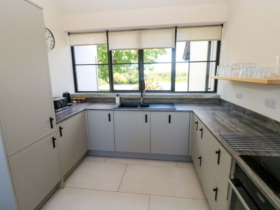 A kitchen with cabinets and a sink at Just A Cottage in St Florence