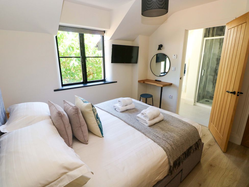A bedroom with a bed and television at Just A Cottage St Florence
