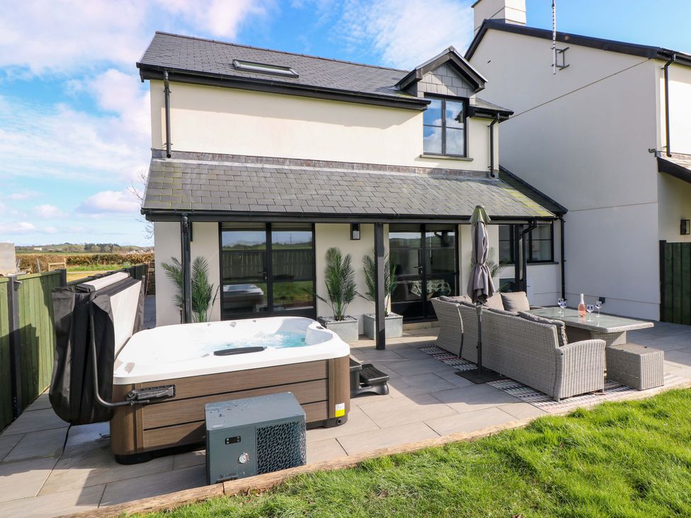 A house with a patio and a hot tub at Just A Cottage in St Florence