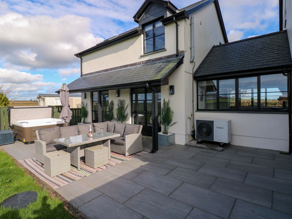 An outdoor space with seating and hot tub at Just A Cottage St Florence