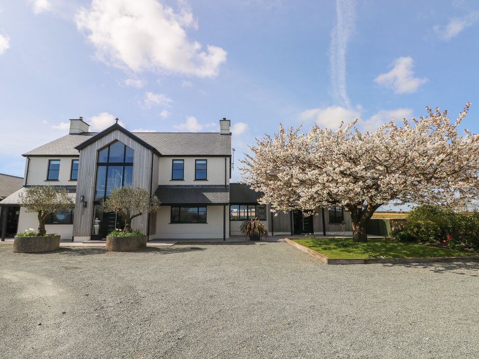 A house with a tree and parking area at Just A Cottage in St Florence