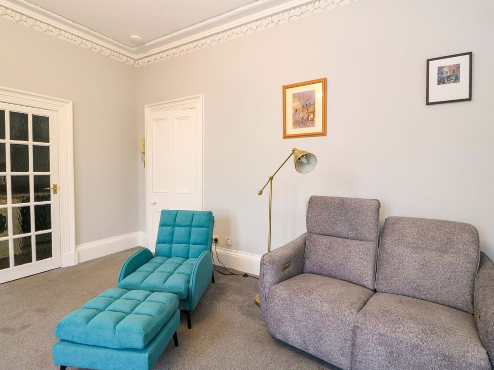 A living room with a sofa and lounge chair at 9A Market Square