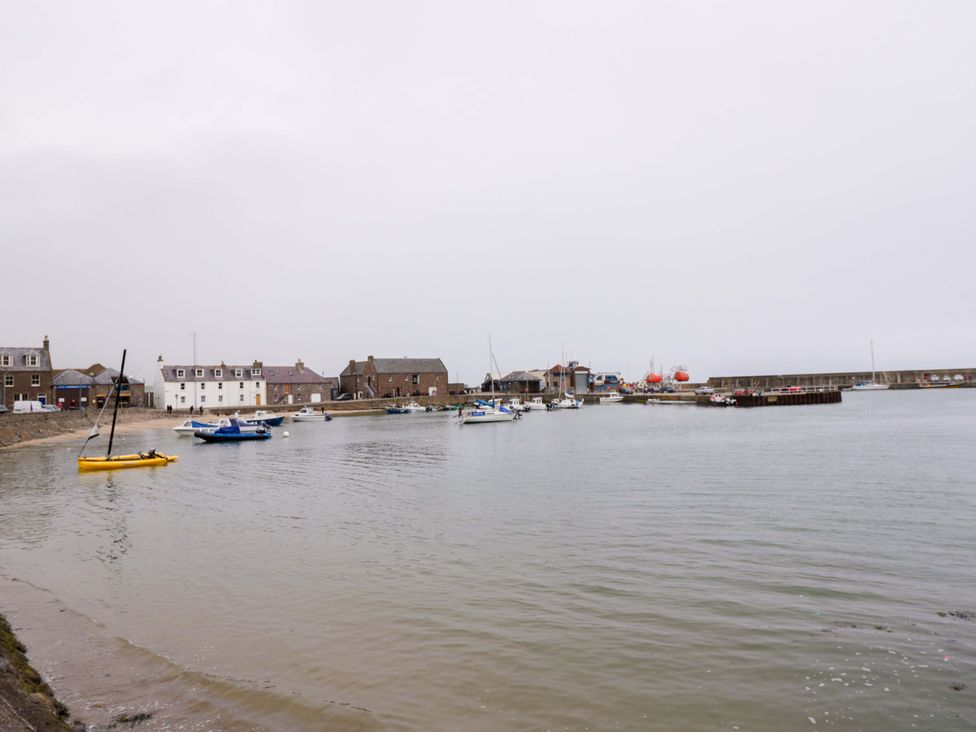 A harbor with boats and buildings at 9A Market Square in 