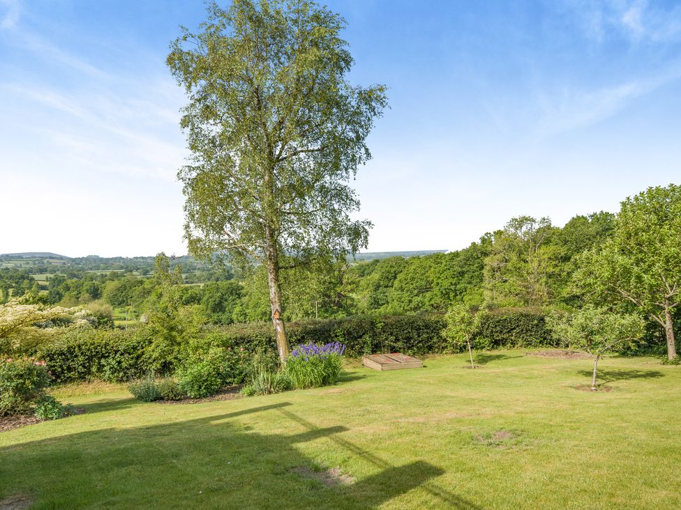 A garden with trees and a view at Underhill House 